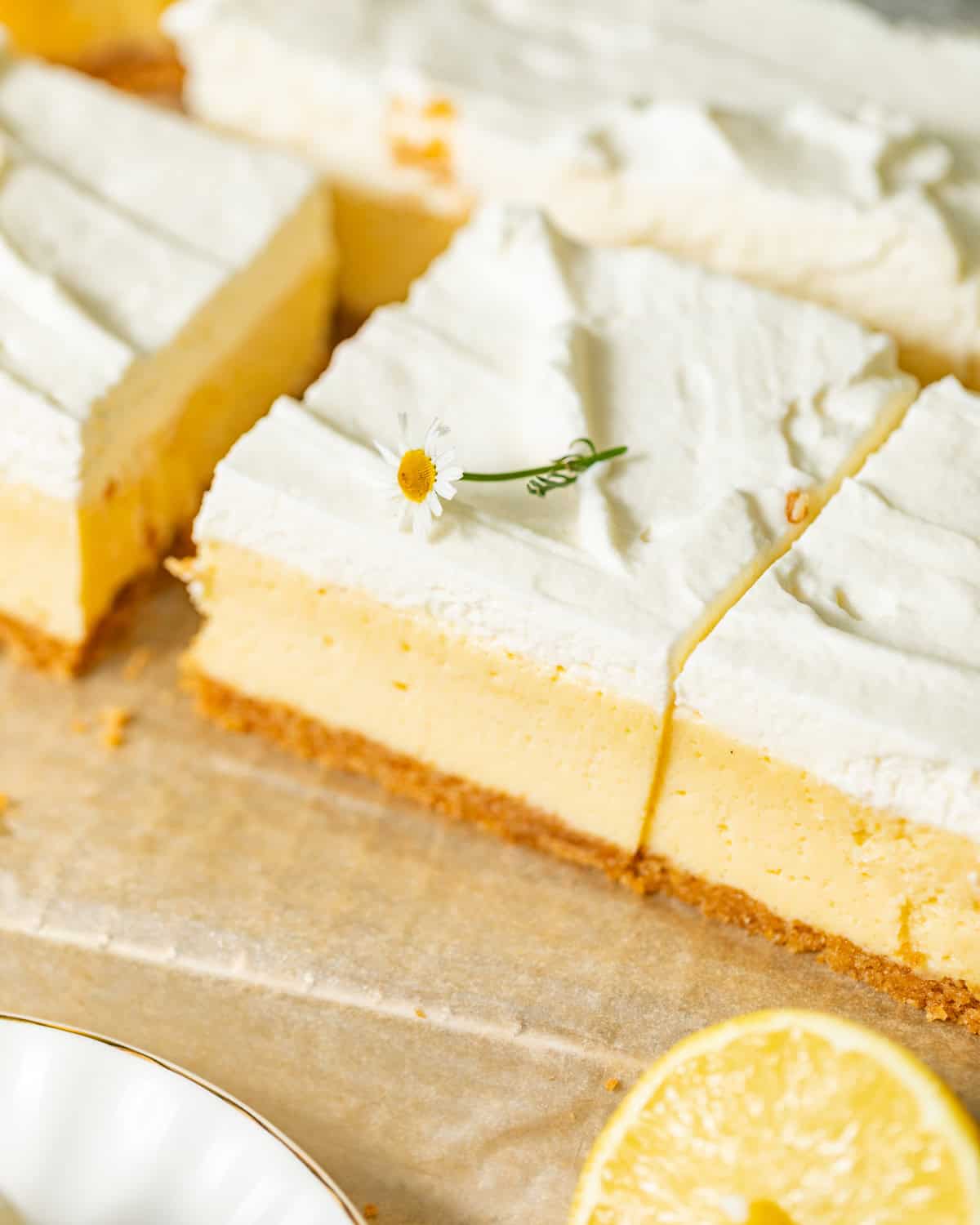 lemon bars on parchment paper cut into slices.