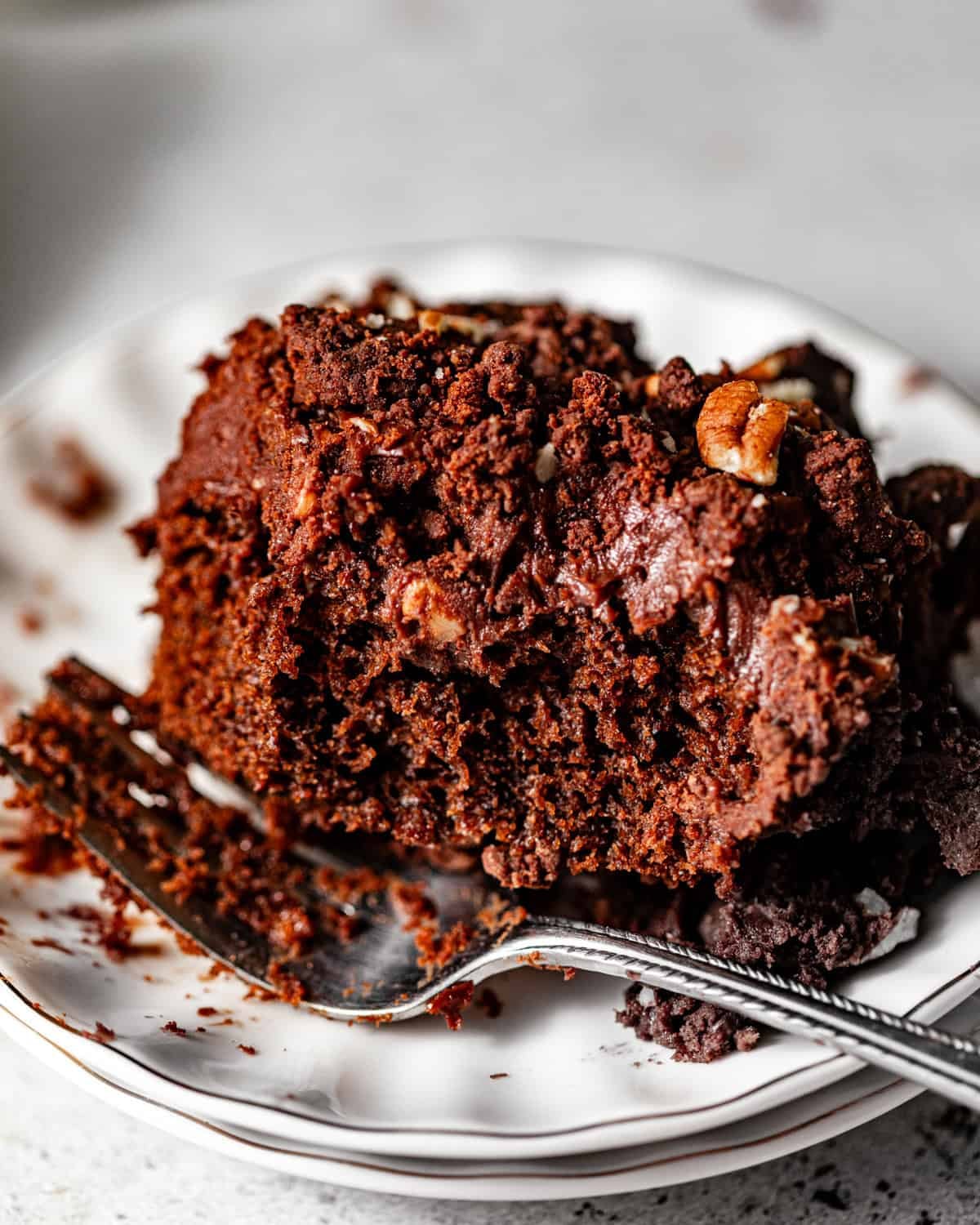 texas sheet cake on a cake plate with a fork. 