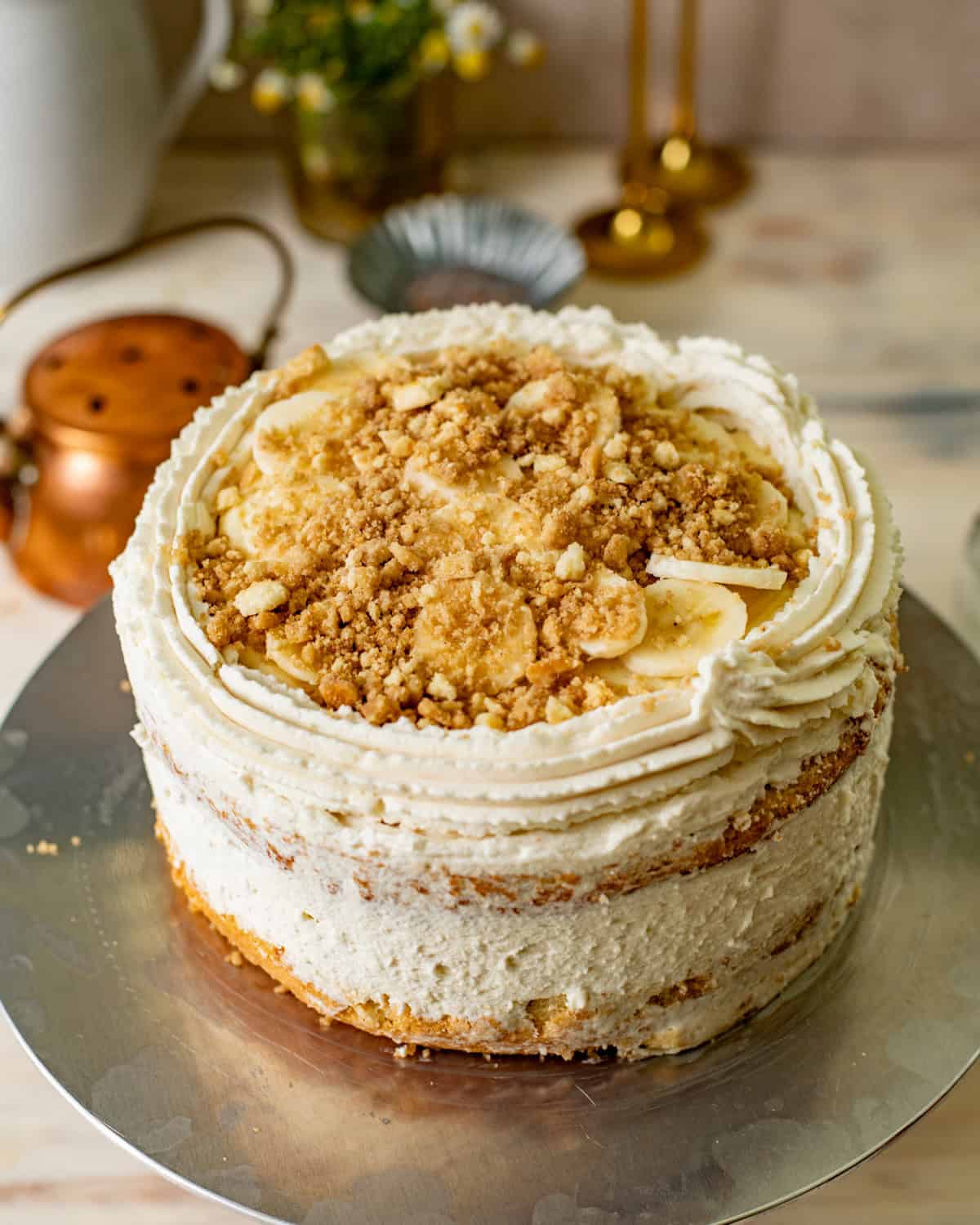 banana pudding layer cake assembled on a cake stand. 