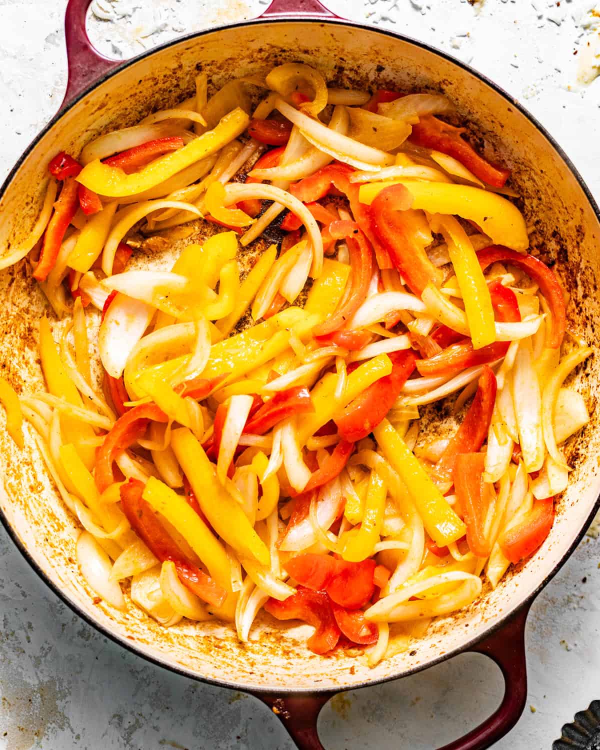 sauteed bell peppers and onions in a skillet.