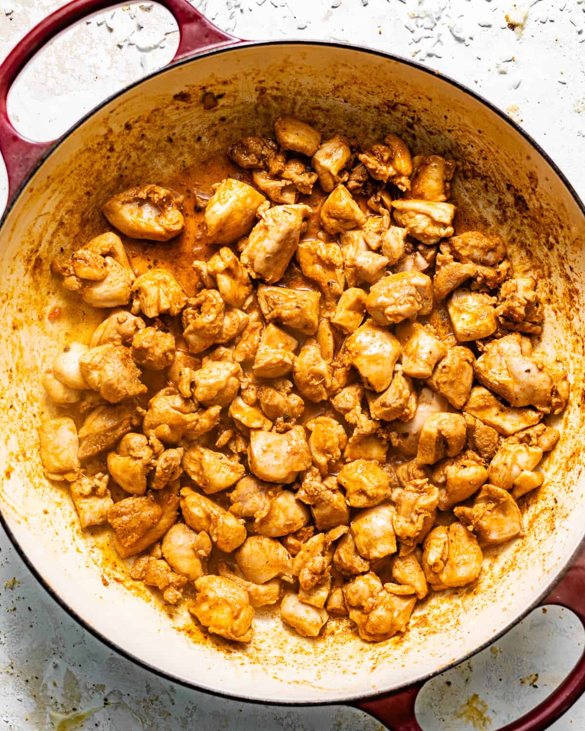 seared seasoned chicken in a skillet.