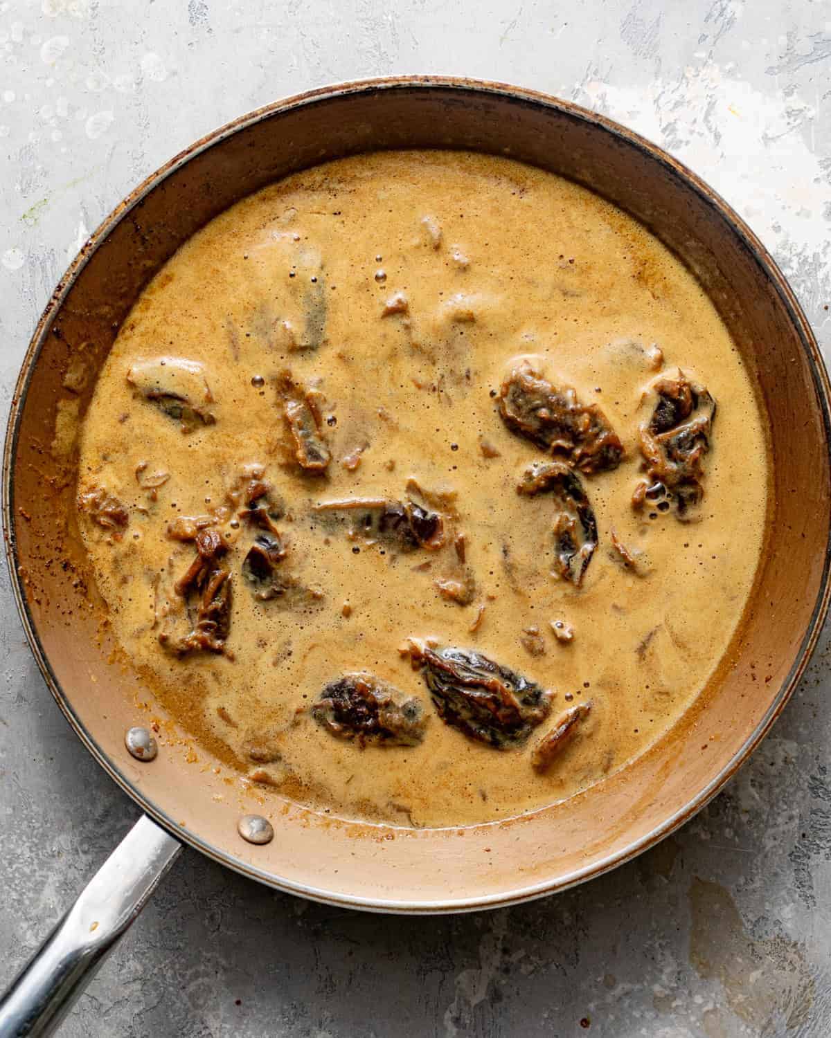 prunes simmering in butter, water, cocoa powder, and melted chocolate.