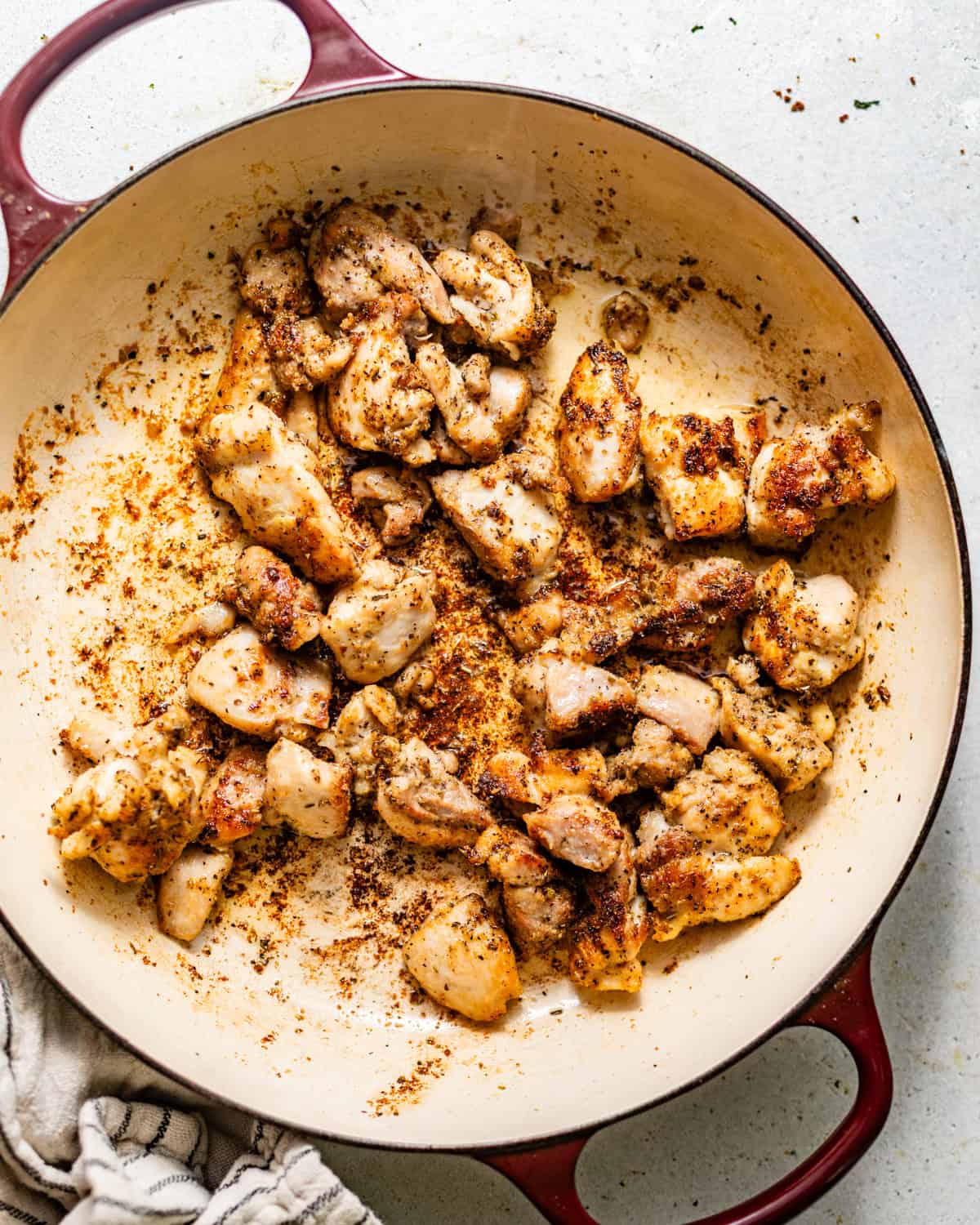 seared chicken bites in a skillet.