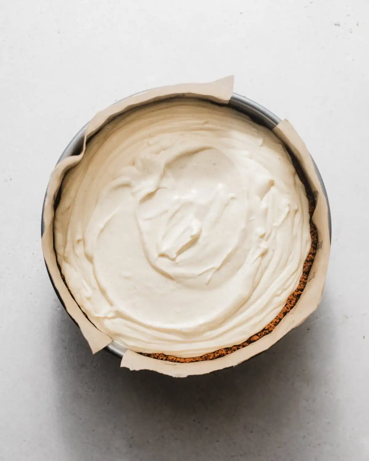 lemon cheesecake filling poured into the graham cracker crust.