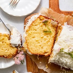 sliced pineapple bread on a serving board topped with edible flowers.