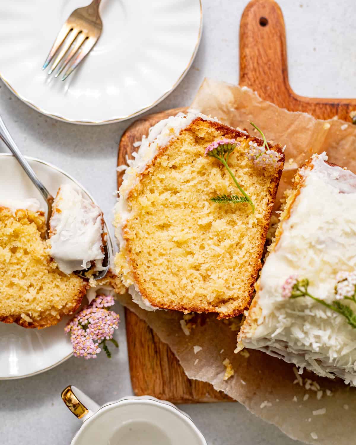 sliced pineapple bread on a serving board topped with edible flowers.