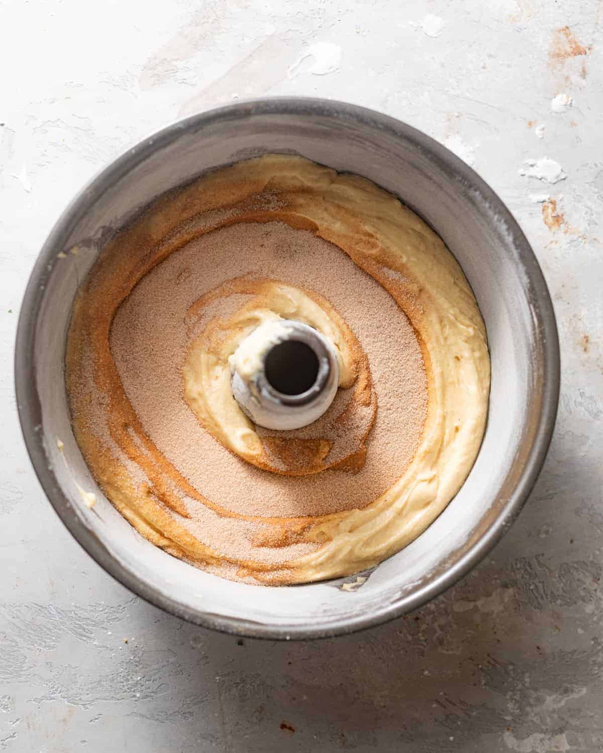 cinnamon roll filling sprinkled on top of the batter.