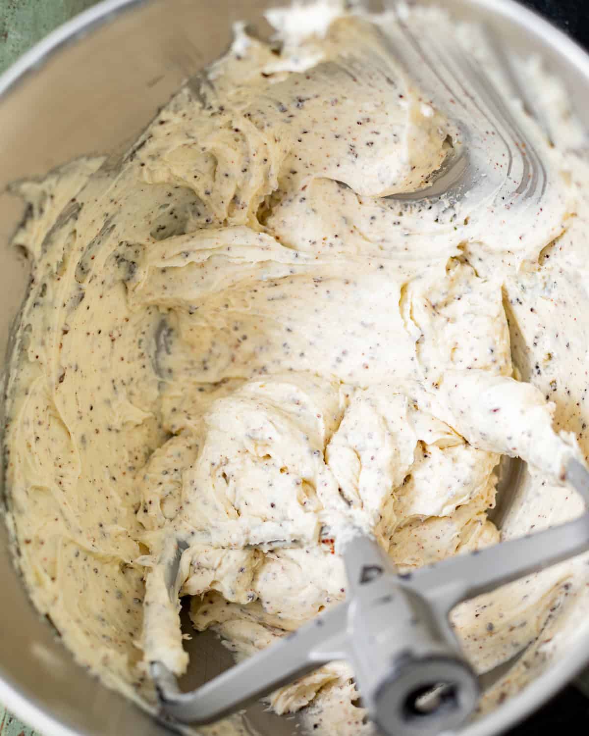 Fluffy brown butter cream cheese frosting with toasted milk solids in a stand mixer.