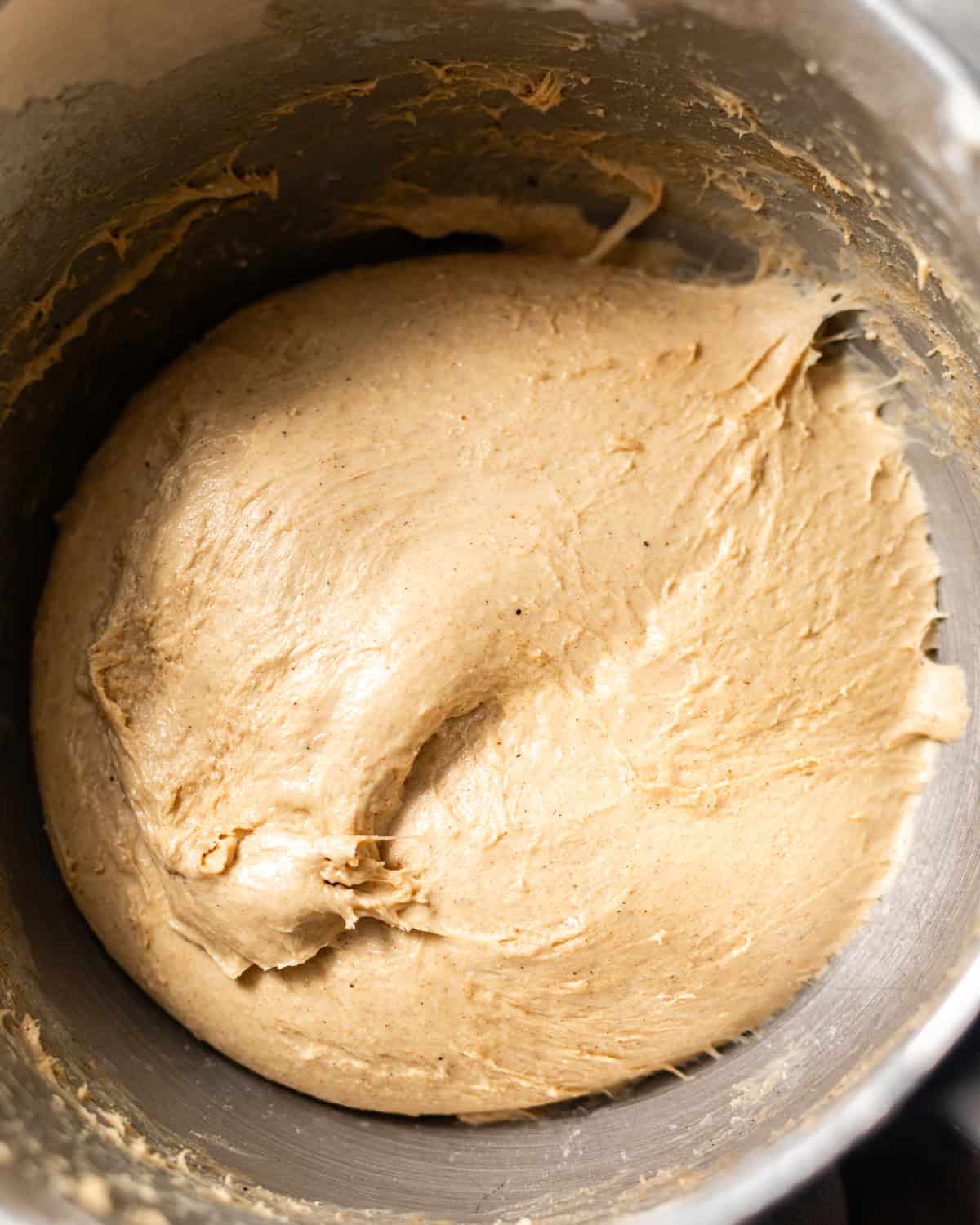 Smooth, elastic yeast donut dough kneaded in a stand mixer and ready for its first rise.