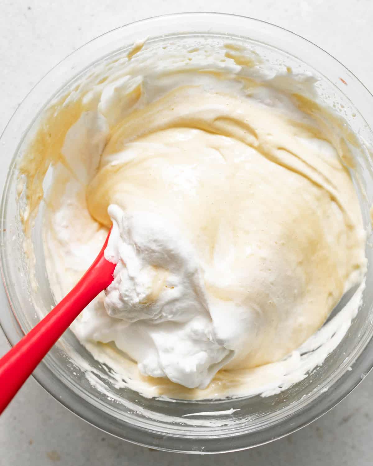 whipped egg whites folded into the egg yolk mixture to form the tres leches batter.