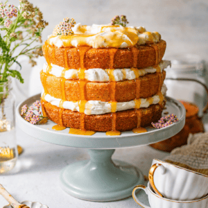 Milk and honey layer cake with whipped cream filling and golden honey drizzled generously over the top and down the sides.