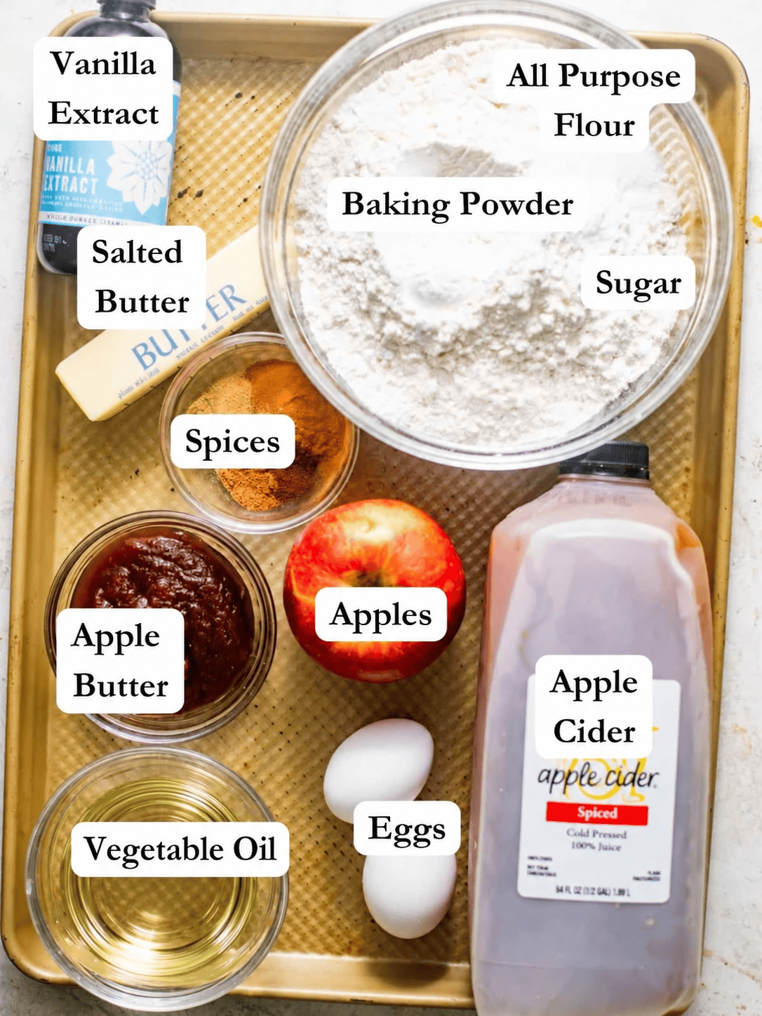 apple cider donut bread ingredients - flour, sugar, apple cider, apple butter, spices, vegetable oil, eggs, vanilla extract, and butter.