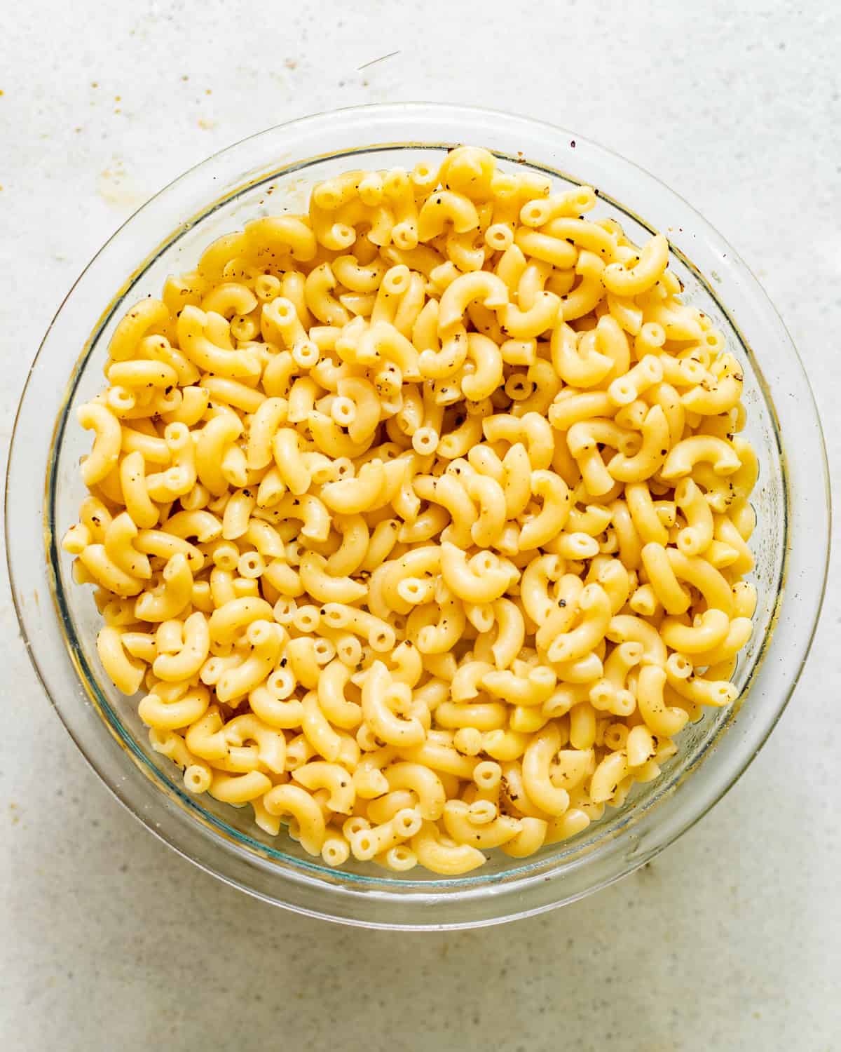 cooked elbow noodles seasoned with salt, pepper, and chicken bouillon paste.