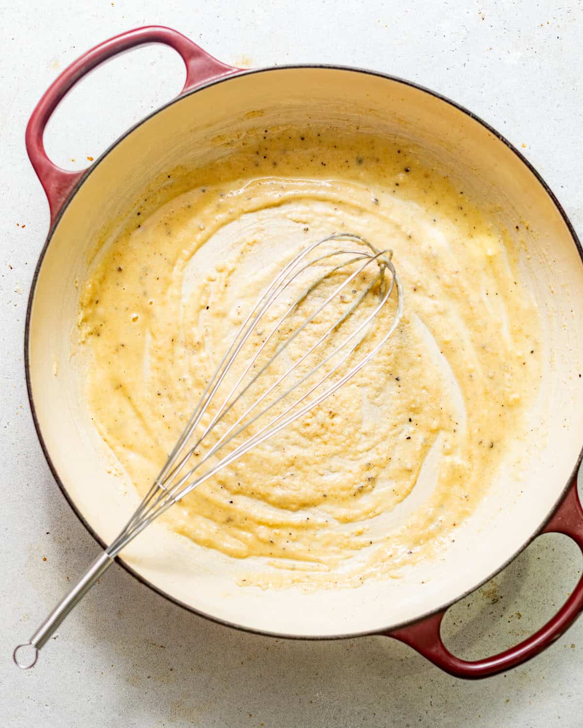 melted butter, seasonings, and flour mixed together in a pot to form the roux for the cheese sauce.