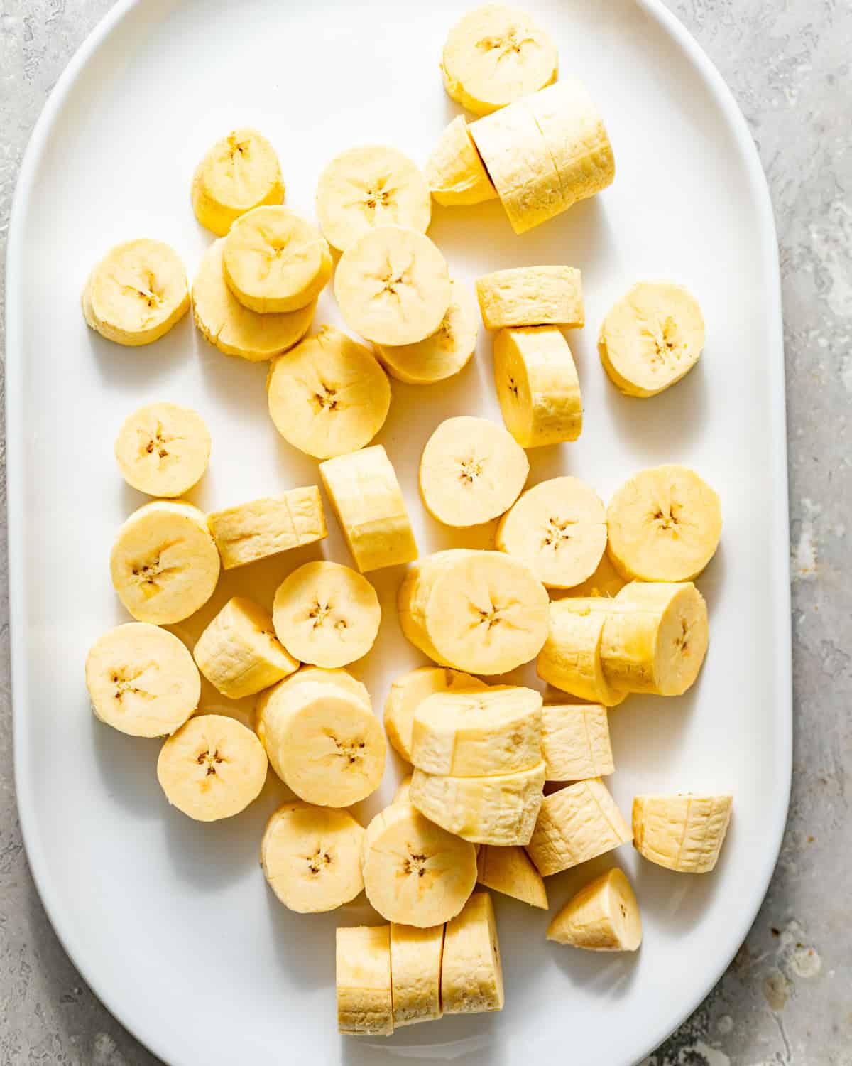sliced green plantains on a plate.