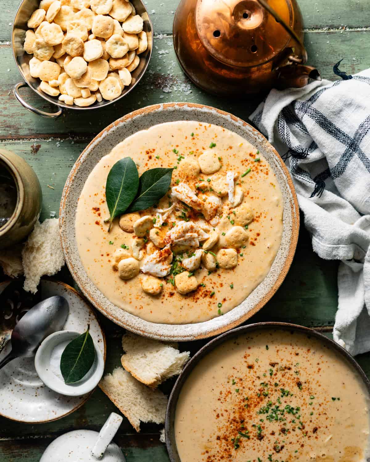 she crab soup in a bowl in a bowl with a spoon, topped with oyster crackers and jumbo lump crab meat.