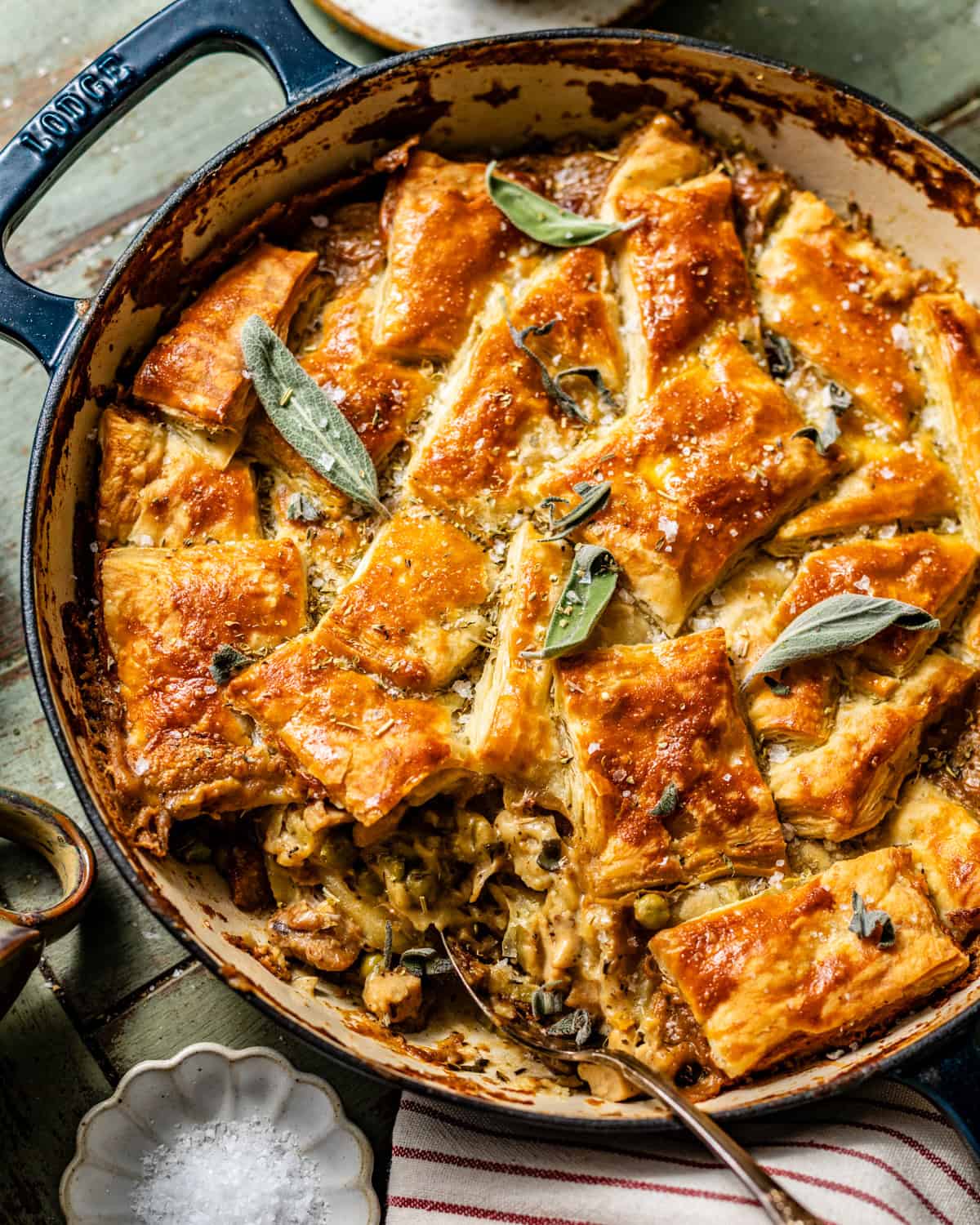 chicken pot pie cooked in a pan and topped with golden puff pastry.