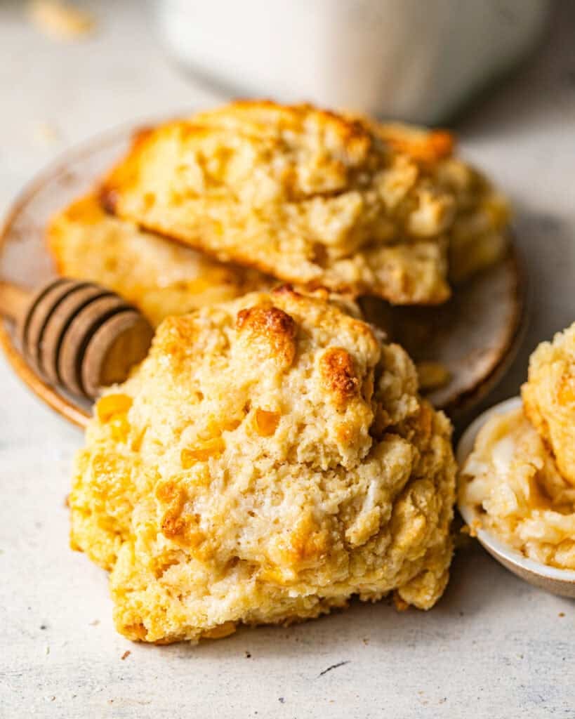 baked cornbread drop biscuits with a fluffy, tender interior and sweet corn kernels, served with homemade honey butter.