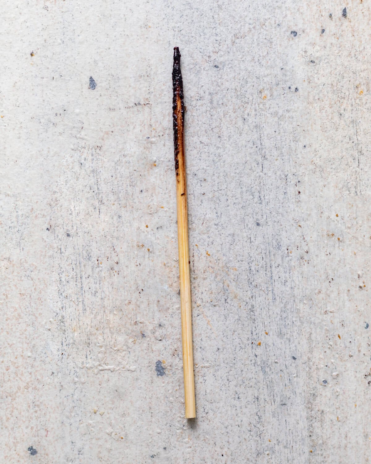 a photo of a toothpick showing how the toothpick should look after being inserted into the brownies to signal that they're finished baking.