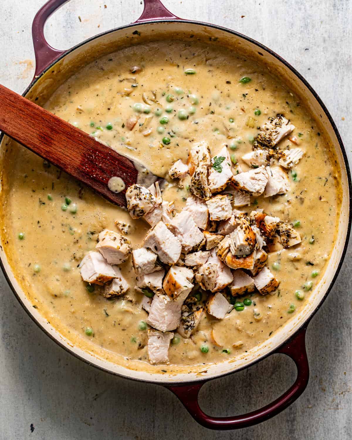 chicken pot pie filling cooked in a pan with the cut up chicken breast added back in.