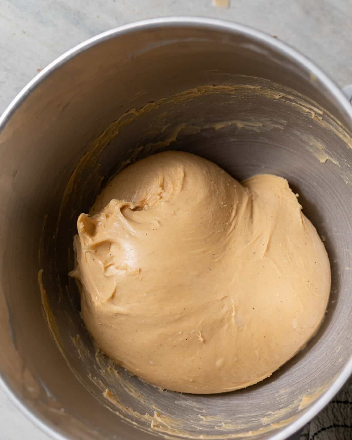 sweet potato cinnamon roll dough in a stand mixer.
