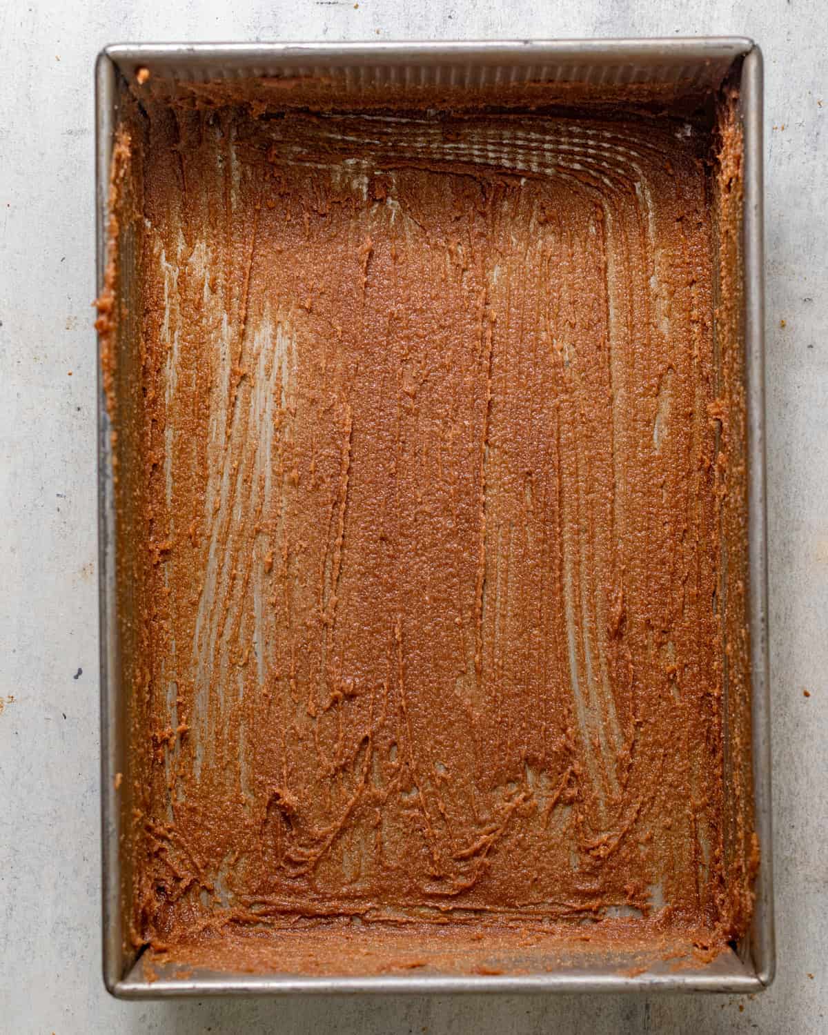 pan sauce spread along the bottom of a rectangular baking pan.