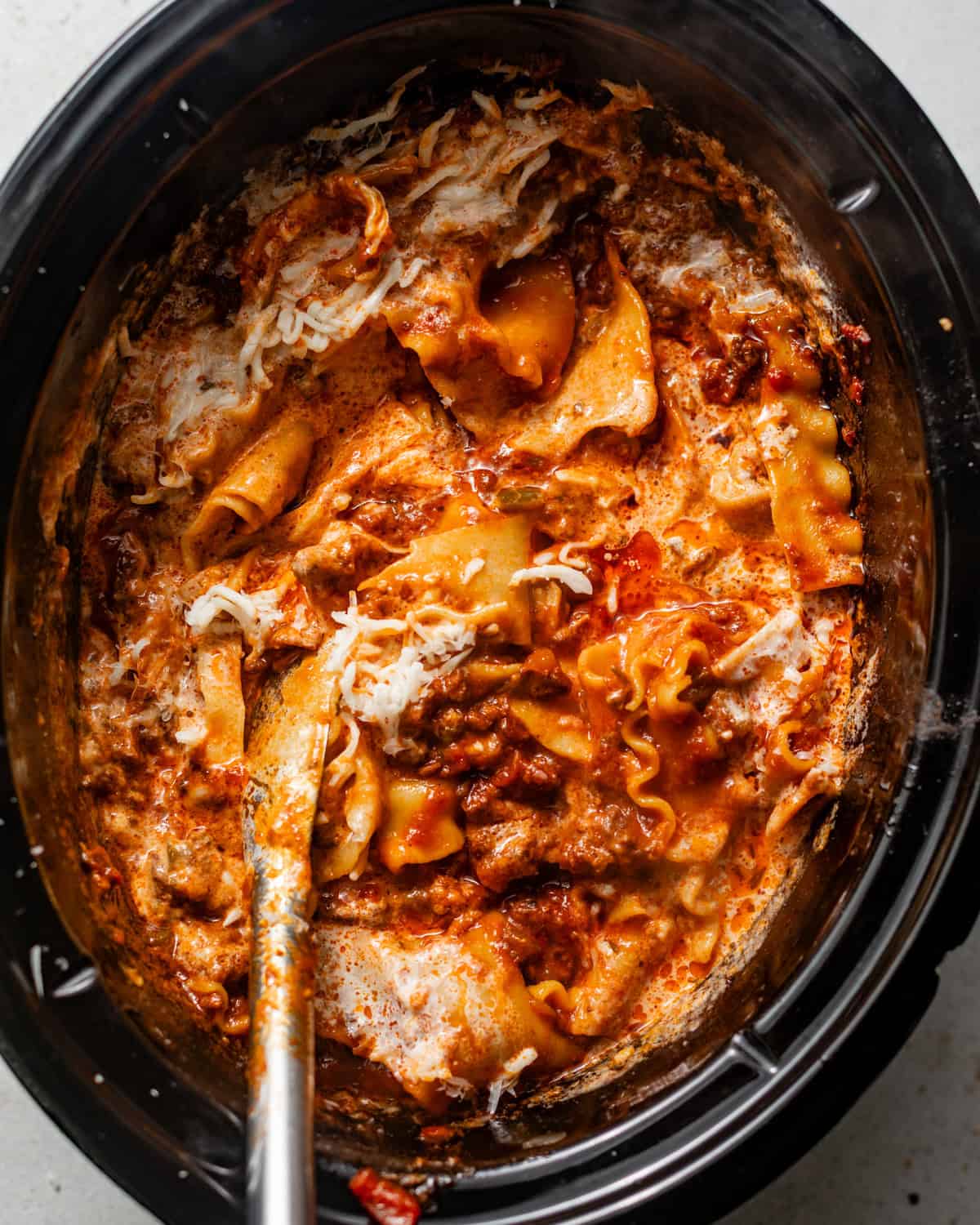 lasagna noodles added to the slow cooker along with cream and cheese.