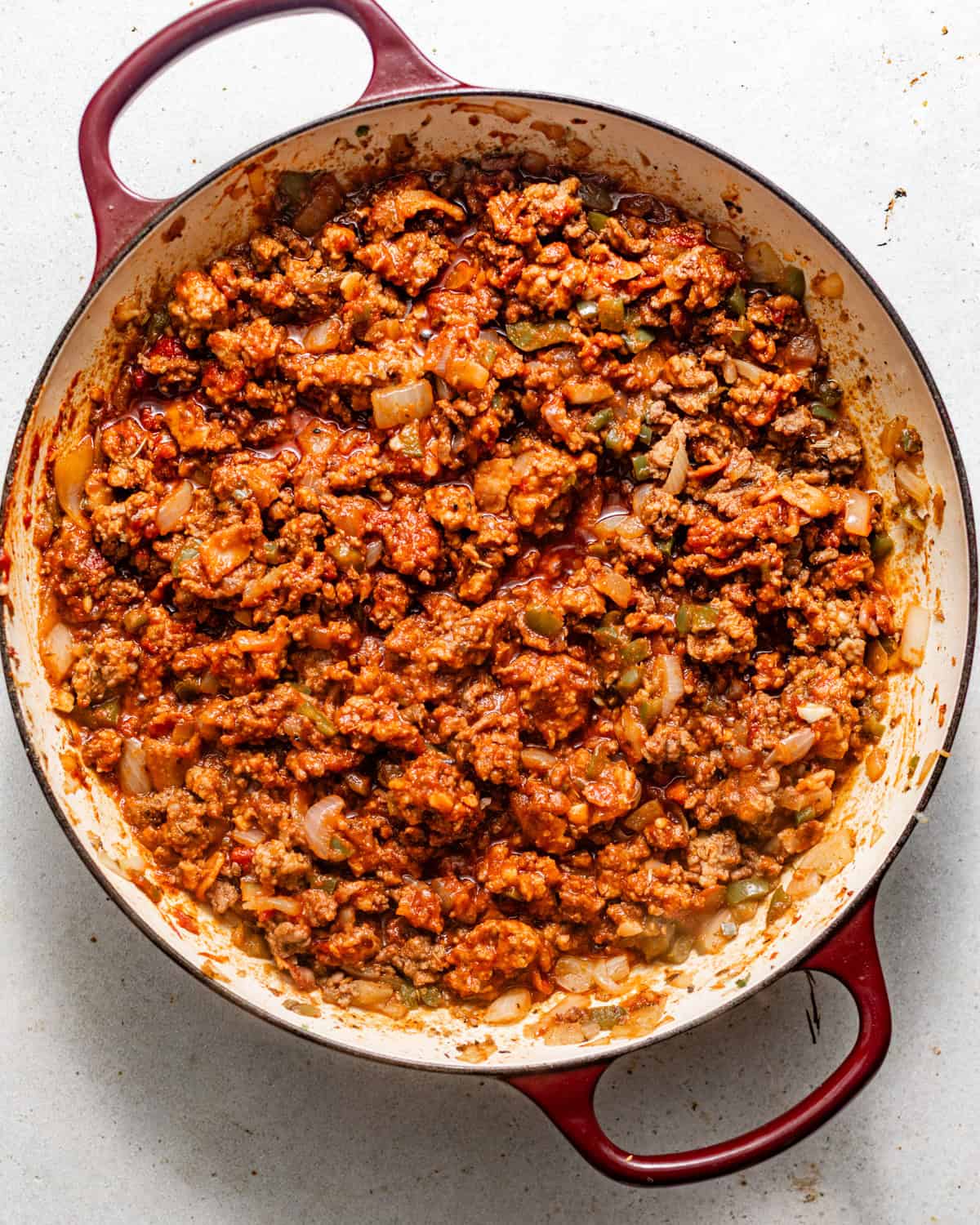 ground beef and italian sausage cooked in a skillet with tomato paste, bacon, and seasonings.