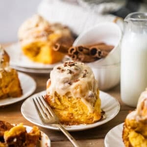 sweet potato cinnamon rolls on a small plate with a fork.